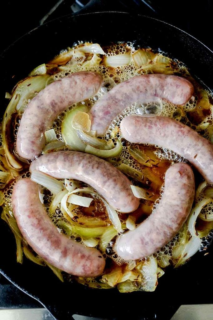 Bratwurst in pan with onions and beer foodiecrush.com