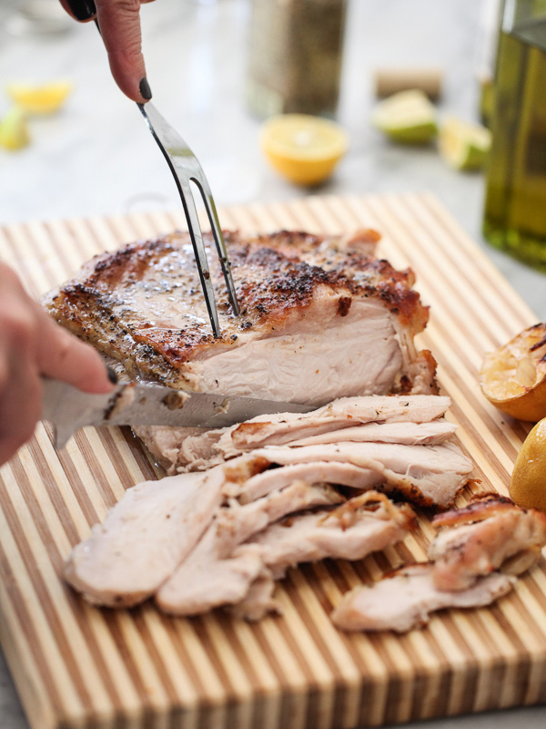 slicing baked turkey breast on cutting board