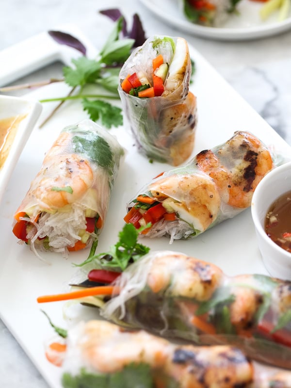 Grilled shrimp spring rolls on white platter