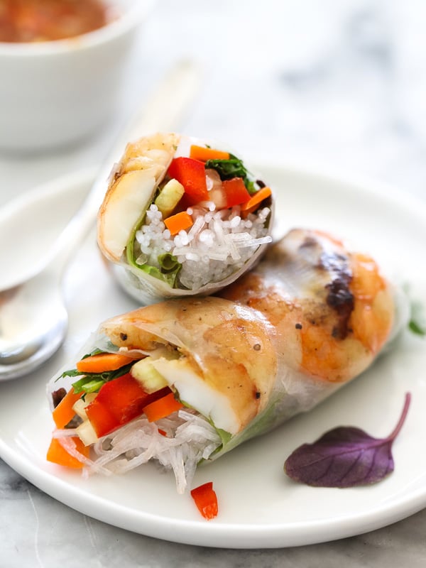 two shrimp spring rolls on a white plate
