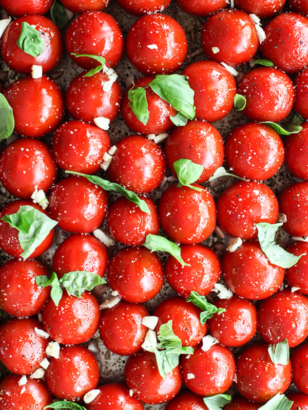 fresh tomatoes and basil prepped for making roasted tomato sauce