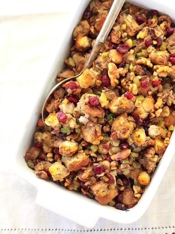 best turkey stuffing in white baking dish with serving spoon