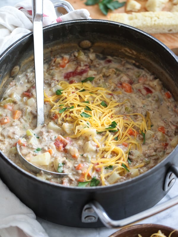 cheeseburger soup in large pot with ladle 