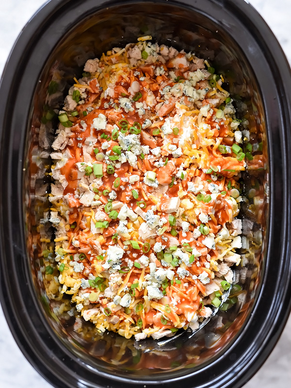 making crockpot buffalo chicken dip with blue cheese