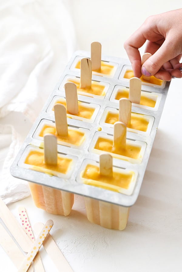 Creamy Mango Popsicles foodiecrush.com 