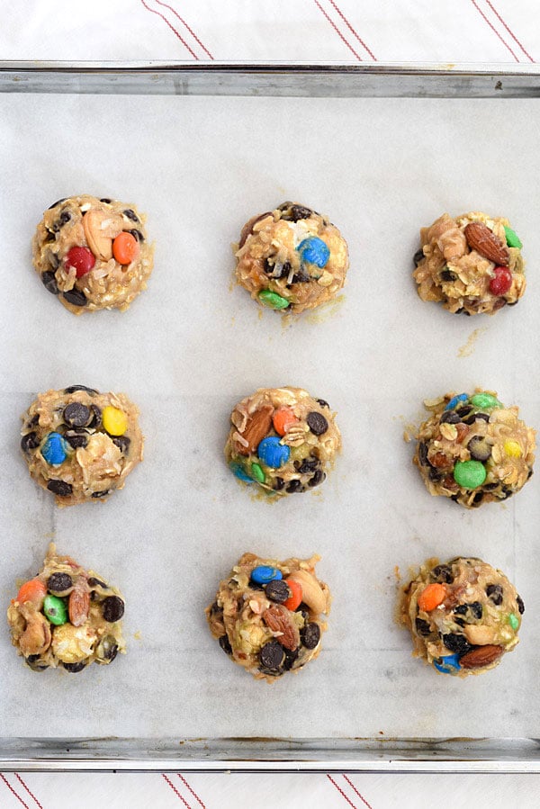 Loaded Monster Cookies pack in all the flavors with whole wheat pastry flour, nuts, oatmeal, popcorn, and coconut. And don't forget the chocolate for a healthy twist on dessert | foodiecrush.com