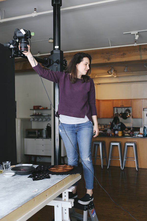 woman prepping lights for cookbook photo shoot