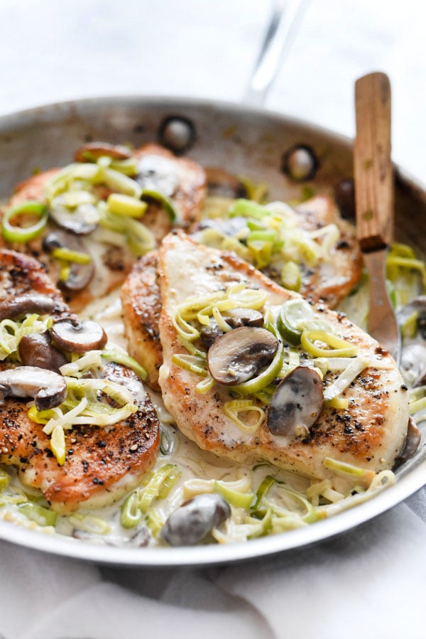 chicken with mushroom sauce and leeks in skillet