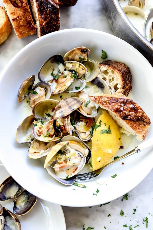 How to make the BEST steamed clams with wine and just a touch of cream | #easy #recipe #wine #butter #garlic foodiecrush.com