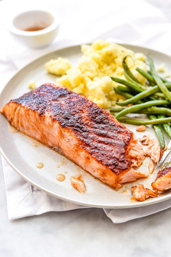 maple glazed salmon fillet on plate with green beans and corn