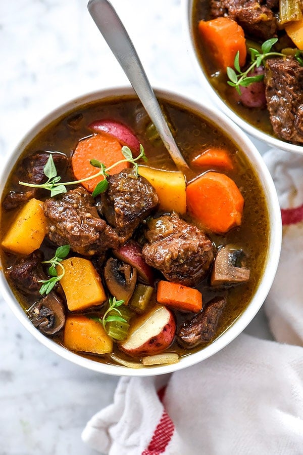 instant pot beef stew in white bowl with fork