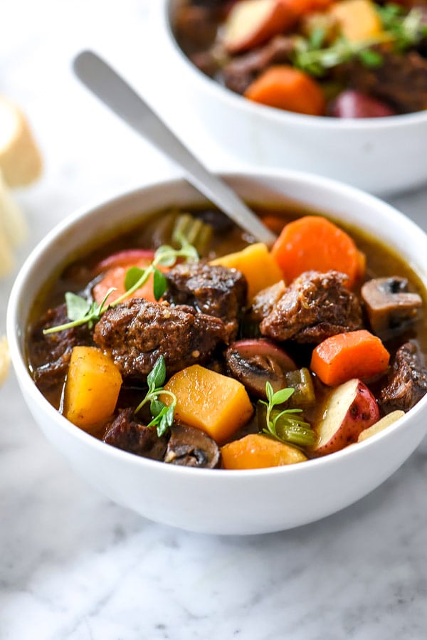 instant pot or slow cooker beef stew in white bowl