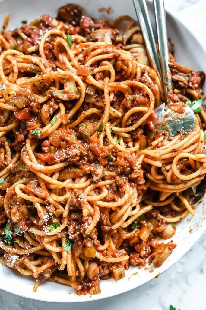 homemade spaghetti sauce and noodles in white dish with two forks