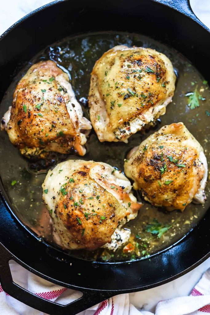 Stuffed Chicken Thighs with Spinach and Goat Cheese is the best 30-minute, cast iron chicken recipe thanks to it's cheesy center and crispy skin | foodiecrush.com #chicken #dinner #recipe #foodblogger #spinach #cheese
