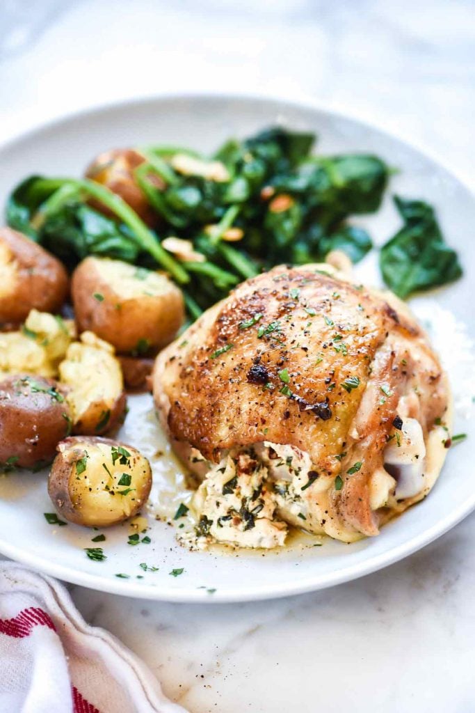 Stuffed Chicken Thighs with Spinach and Goat Cheese is the best 30-minute, cast iron chicken recipe thanks to it's cheesy center and crispy skin | foodiecrush.com #chicken #dinner #recipe #foodblogger #spinach #cheese