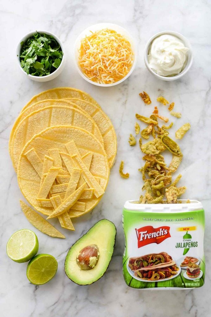 easy chicken tortilla soup toppings on marble countertop
