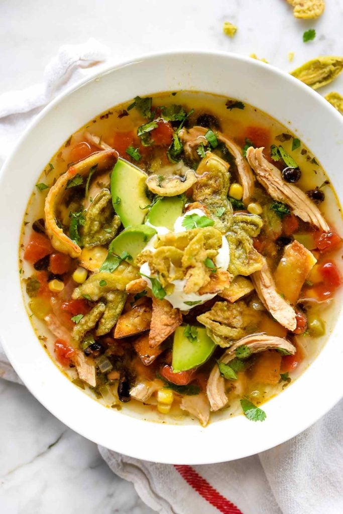 bowl of chicken tortilla soup with toppings