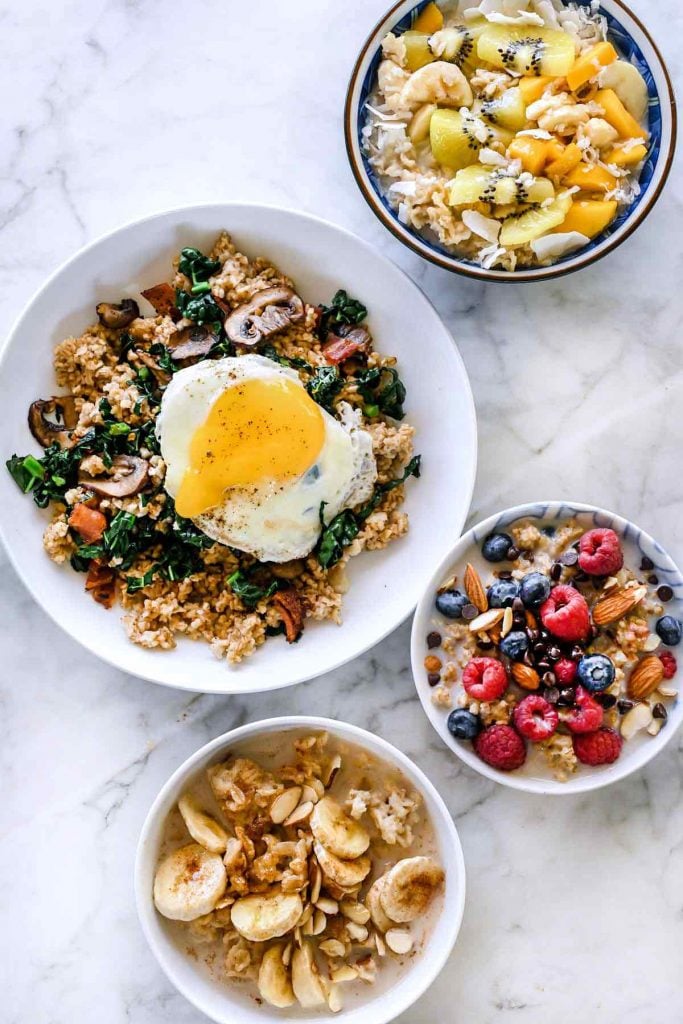 four bowls of homemade oatmeal with various sweet and savory toppings