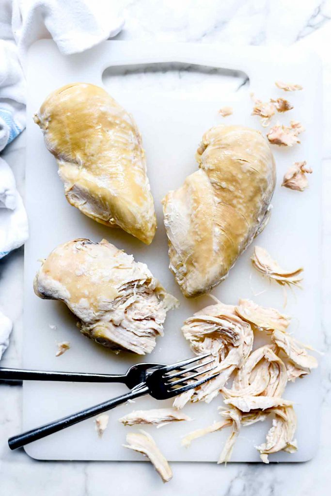 three instant pot chicken breasts on cutting board
