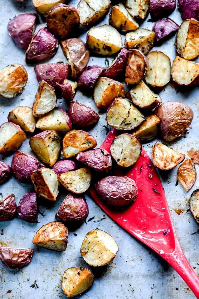 oven roasted red potatoes on baking sheet with red spatula