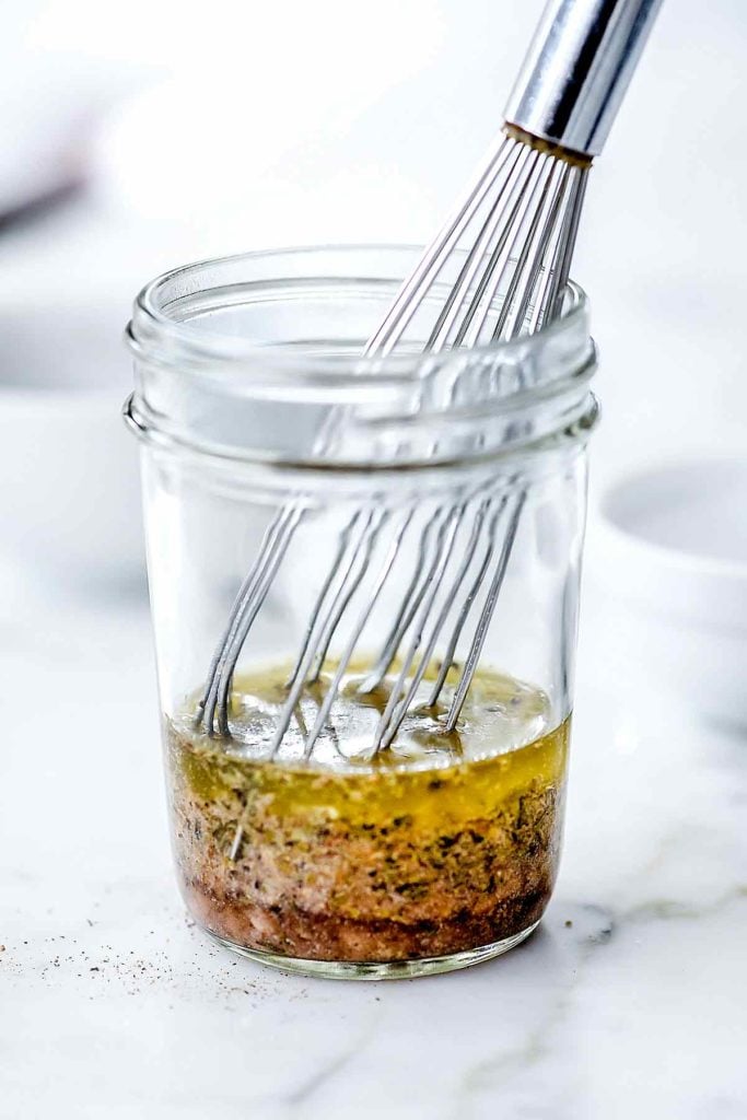 Greek salad dressing in mason jar with whisk