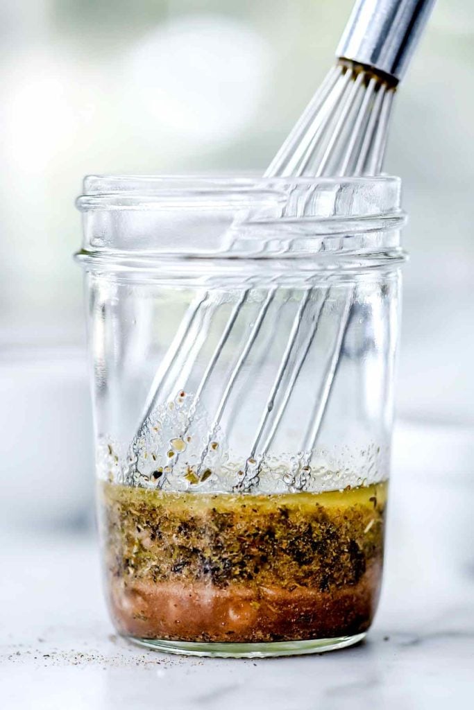 Greek Salad Dressing in mason jar with whisk