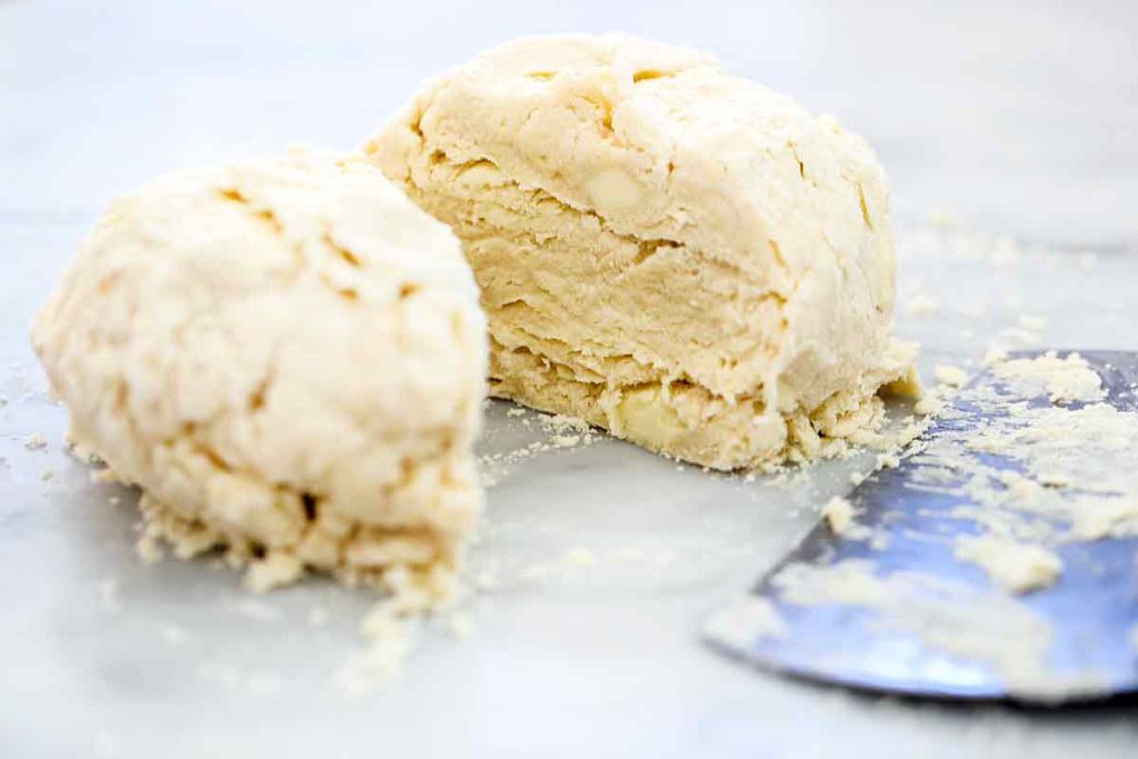 butter pie crust divided into two balls of dough