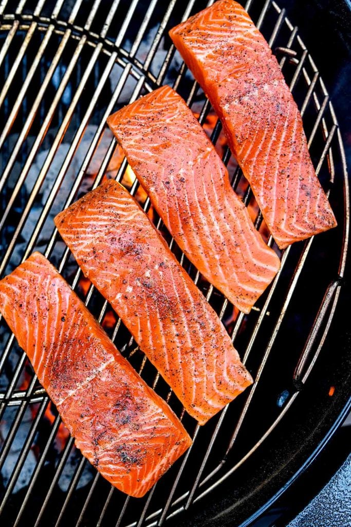 Four fillets of salmon on a charcoal grill