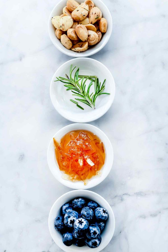 Toppings Baked Brie Blueberries Jam and Almonds foodiecrush.com #appetizer #recipes #baked #brie #holiday #jam #blueberries