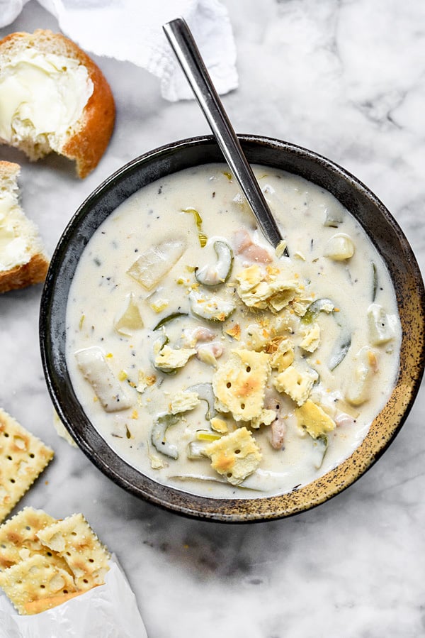 bowl of clam chowder garnished with saltine crackers