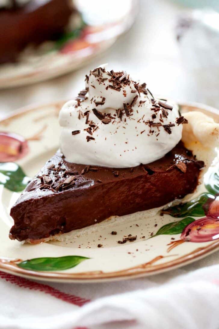 Chocolate Cream Pie on a plate with whip cream foodiecrush.com 