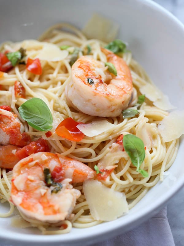 shrimp scampi with angel hair pasta in white bowl