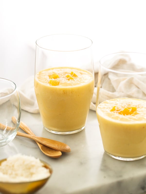 two glasses filled with homemade mango smoothie