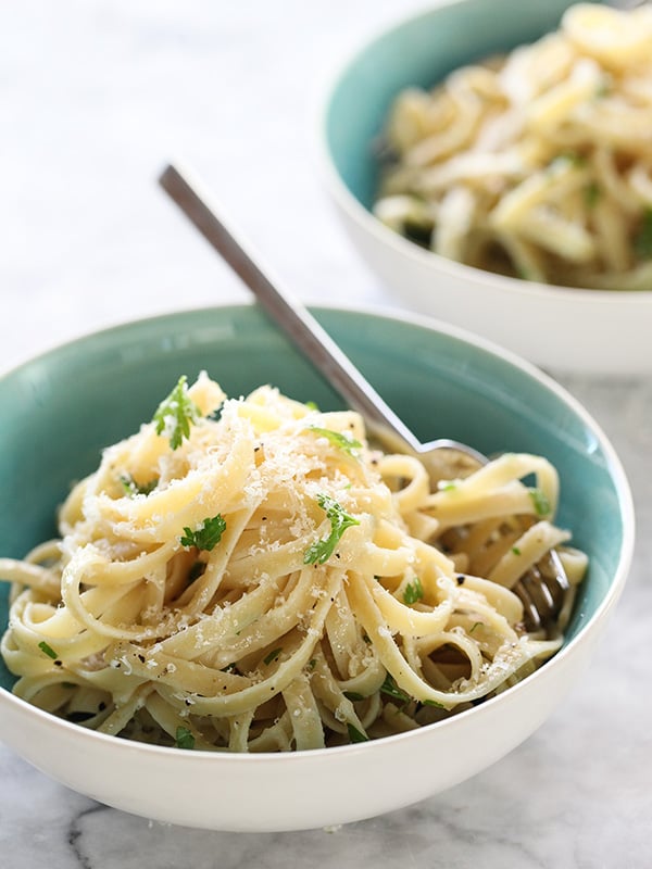 buttered noodles in a blue and white bowl