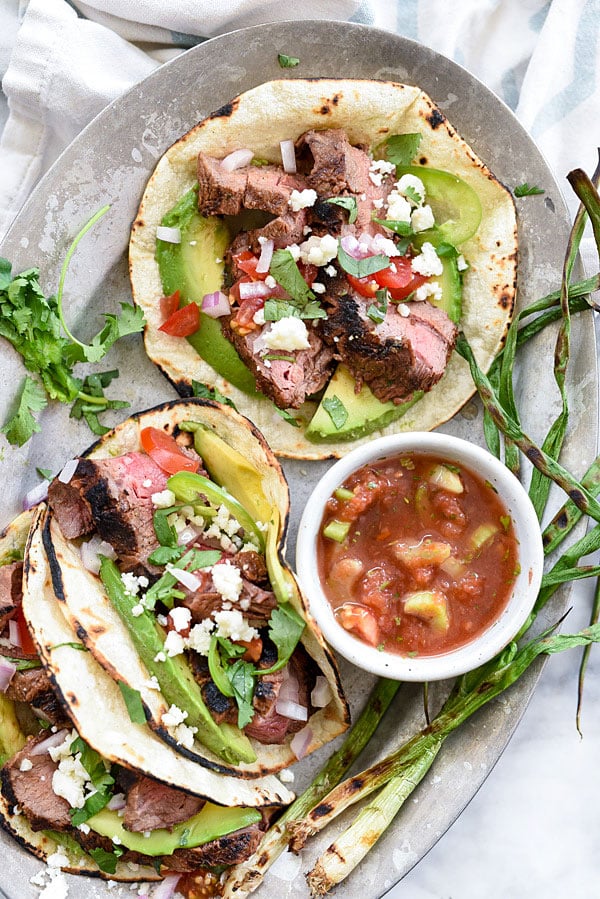 Grilled Steak Tacos marinated in a citrus adobo sauce for tons of flavor on foodiecrush.com