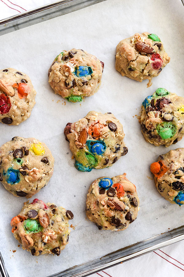 Loaded Monster Cookies pack in all the flavors with whole wheat pastry flour, nuts, oatmeal, popcorn, and coconut. And don't forget the chocolate for a healthy twist on dessert | foodiecrush.com