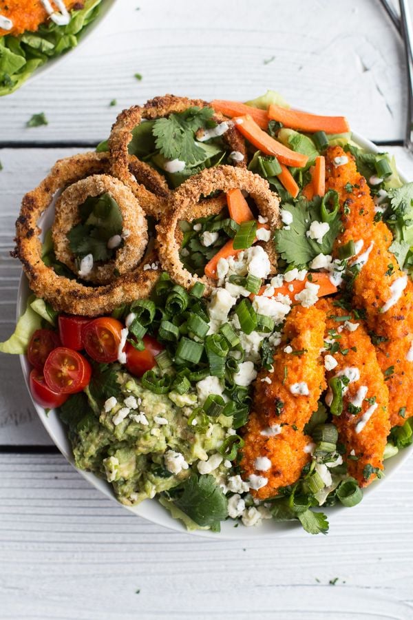 Buffalo Chicken, Blue Cheese Guacamole and Crunchy Baked Onion Ring Salad from halfbakedharvest.com on foodiecrush.com