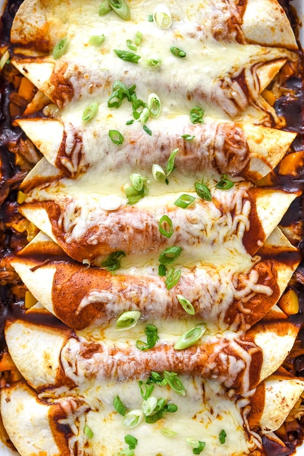 Beef Enchiladas With Butternut Squash topped with red enchilada sauce