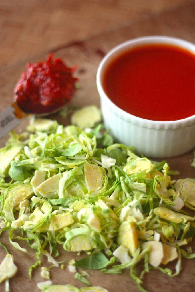 Raw Brussels Sprouts Salad with Harissa Vinaigrette by Project Domestication on foodiecrush.com