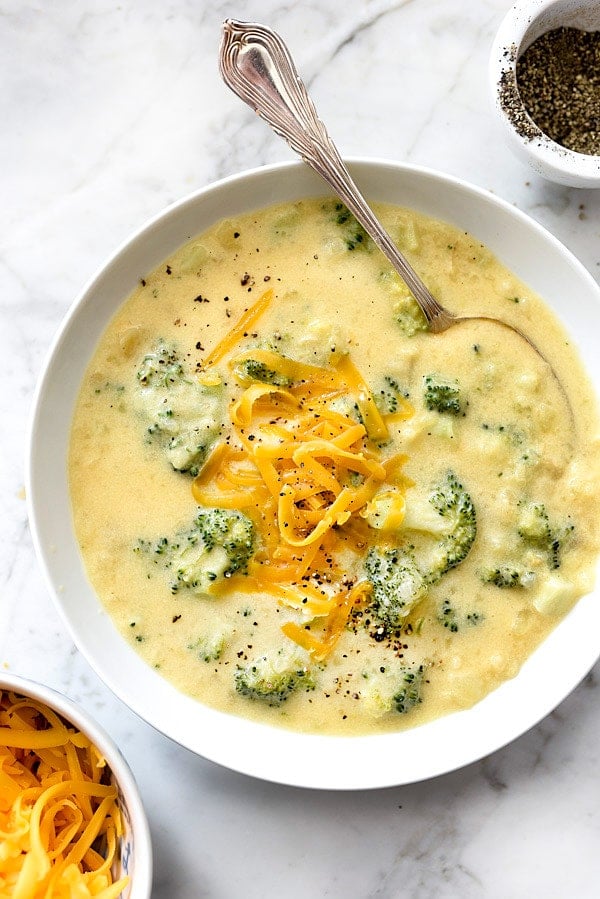 cheesy potato soup with broccoli in white bowl