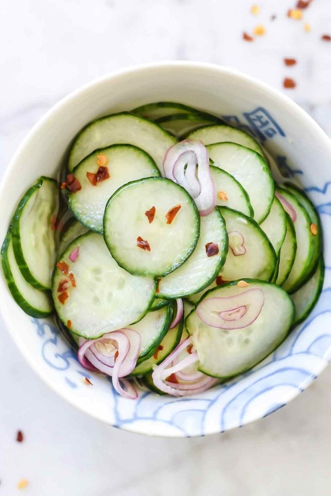 Asian pickled cucumbers in white bowl