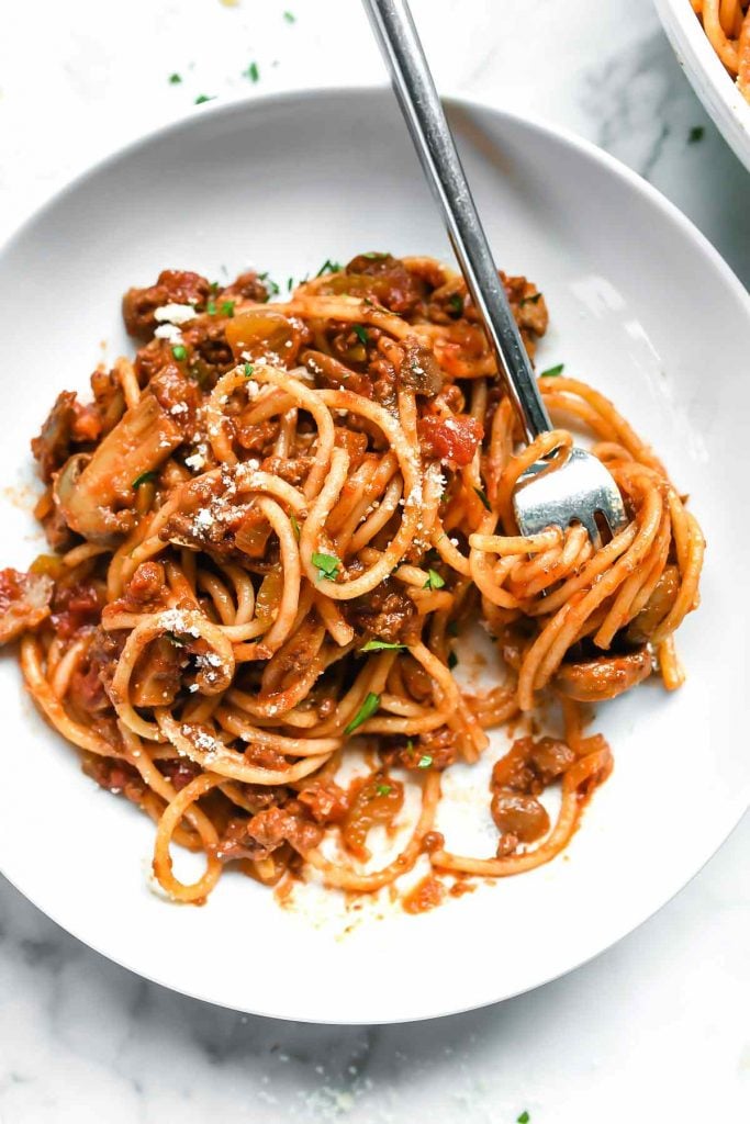 plate of spaghetti sauce and noodles with forks