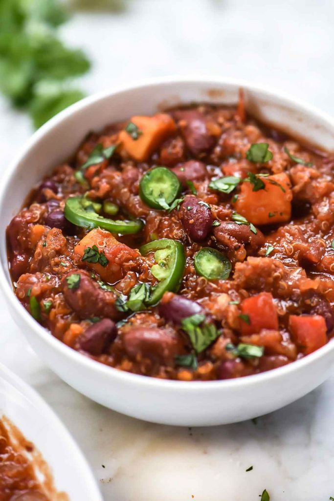 slow cooker turkey chili garnished with jalapeno in white bowl