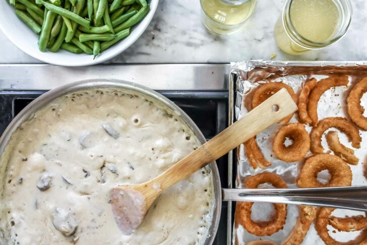 white sauce and onion rings on stovetop meant for homemade green bean casserole
