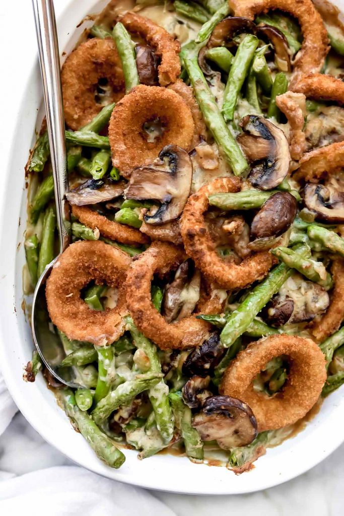best Green Bean Casserole with Onion Rings in white baking dish with spoon