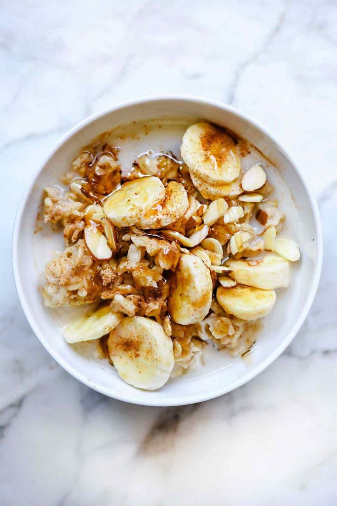 homemade oatmeal topped with bananas and sliced almonds