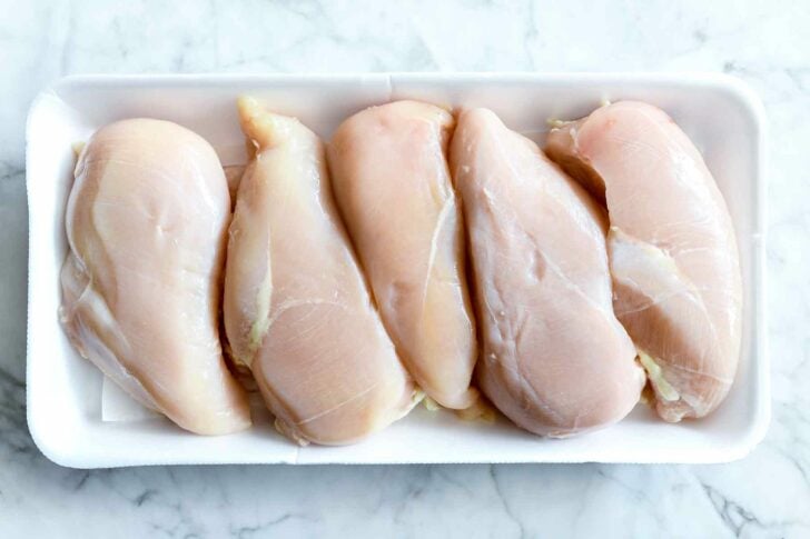 Raw chicken breasts in packaging 