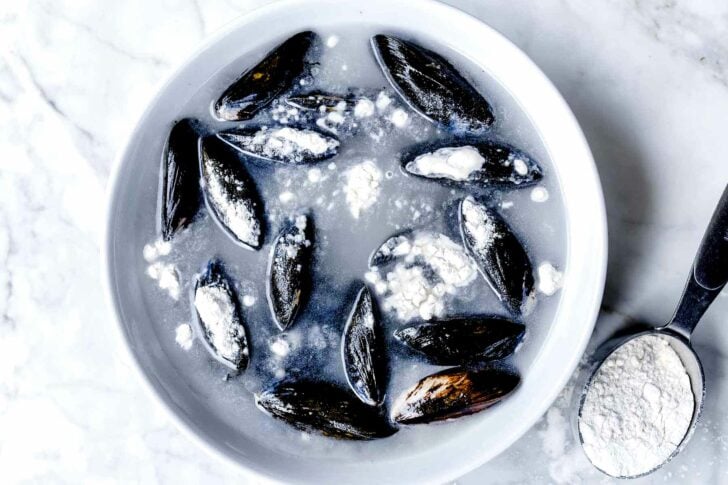 Mussels in flour to rinse the sand from them | foodiecrush.com