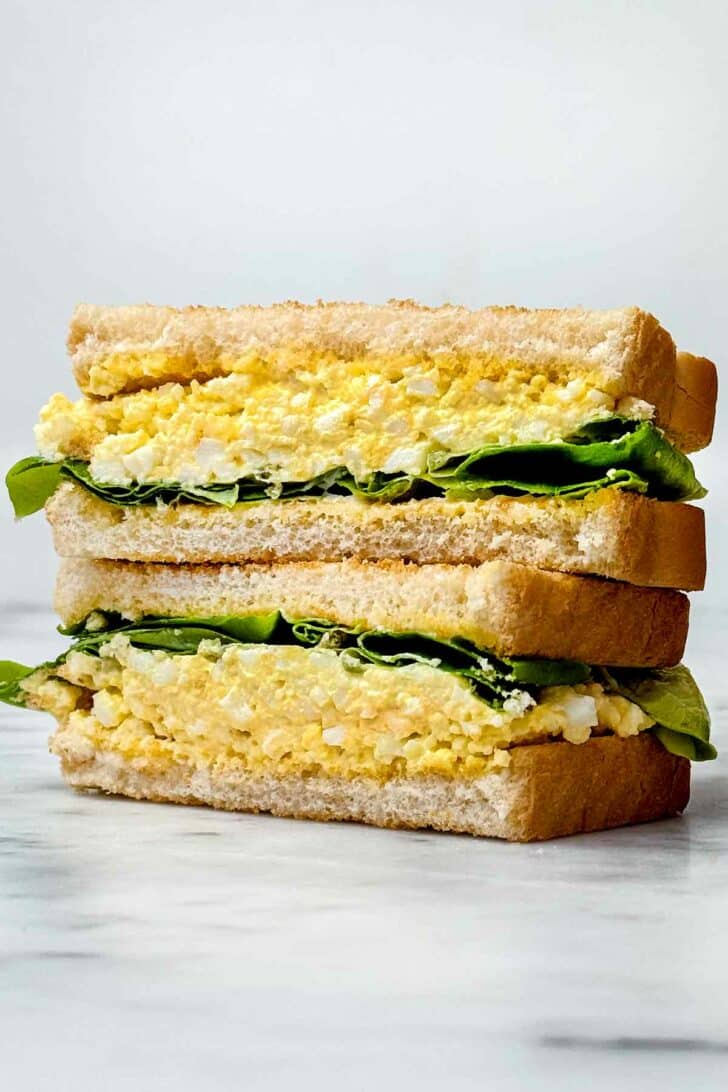 Egg Salad sandwich cut in half stacked foodiecrush.com