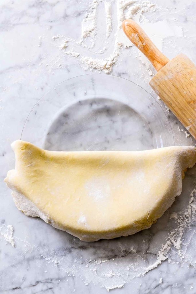 draping the best pie crust over glass pie plate